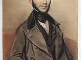 portrait d'un homme en costume-cravate, assis sur une chaise