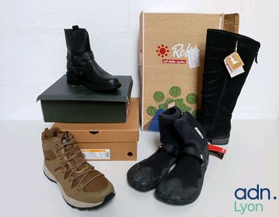 two pairs of boots and a box on a table