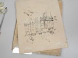 a drawing of a castle on a piece of paper next to a pair of scissors and a pair of scissors