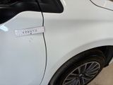 a white car with a sticker on the side of it