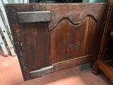 a very old wooden cabinet with a door on it