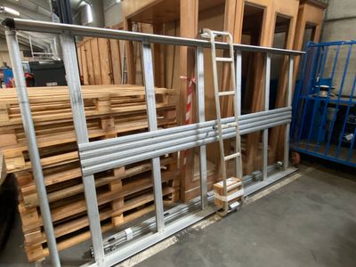many wooden pallets stacked on top of each other in a warehouse