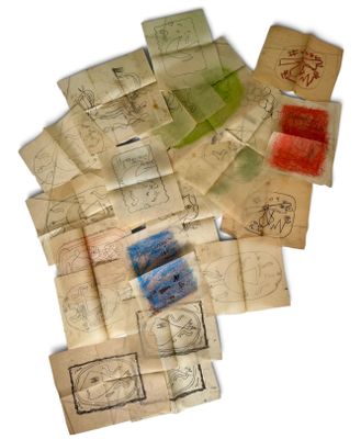 a pile of old papers with drawings on them
