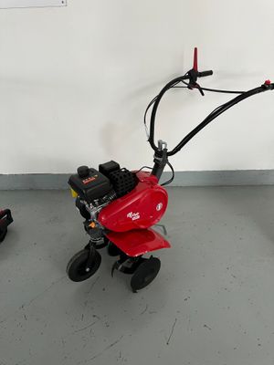 two small lawn mowers that are sitting on the floor