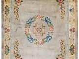 a beige rug with a floral design on it