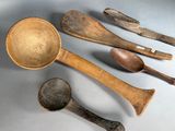 five wooden spoons and two wooden spoons next to each other