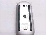 a close up of an apple mouse on a white surface