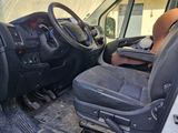 a man sitting in the driver ' s seat of a truck