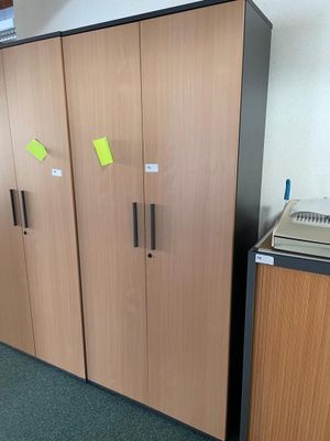 a refrigerator and a refrigerator freezer in a room