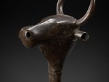 a close up of a wooden stick with a bull head on it