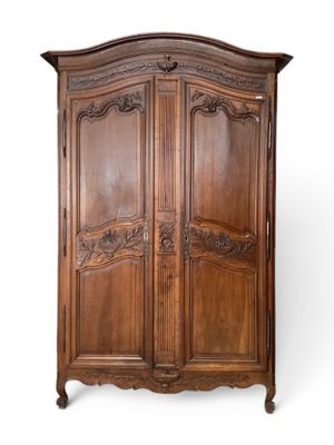 an old wooden armoire with carvings and carvings on the doors