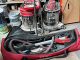 a red bag with tools in it sitting on the floor
