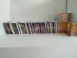 a lot of dvds on a shelf next to each other