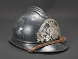 an old fireman ' s helmet with a metal emblem on it
