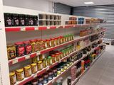 many shelves in the store with various foods on them