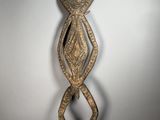 a wooden sculpture of a woman with a face and arms