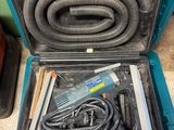 a tool in the case that is sitting on the floor