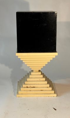 an image of a black and yellow computer on a stand