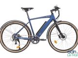 a blue electric bike parked on the side of the road