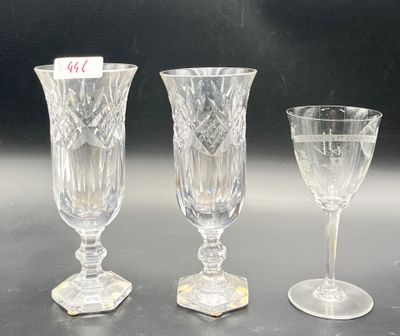 three wine glasses sitting on a table next to each other