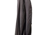 a coat hanging on a clothes rack on a white wall