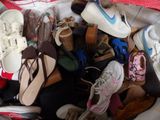 many pairs of shoes in a bag on the floor