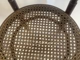 an antique wooden chair with a woven seat and back