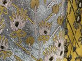a close up of a yellow and black floral print dress