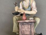a figurine of a man sitting on a table