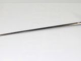 a sword that is laying on a white surface