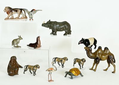 many figurines of animals on display on a white surface
