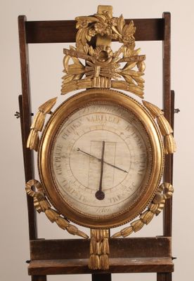 a clock that is on a stand with a clock on it