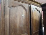 a wooden cabinet with a sign on it in a room