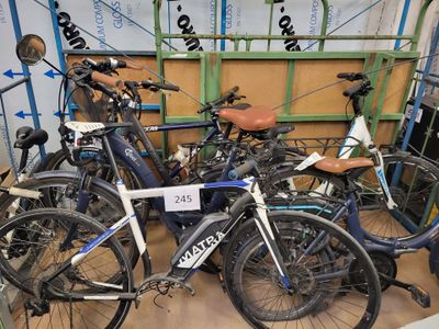 many bicycles that are parked in a room