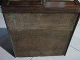 a wooden box with a clock on top of it