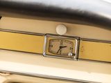a close up of a clock on the dashboard of a car