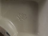 a close up of a white porcelain vase with a heart on it