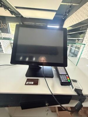 a television sitting on top of a desk with a remote control
