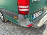 a green truck that is parked in the parking lot