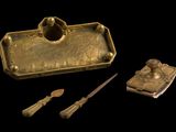 a gold box with a spoon, spoon and spoon rest on it