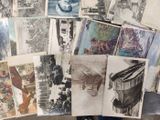 a lot of old photos on the table together
