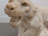 a statue of a dog with a chain around it ' s neck