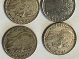four different british coins are shown on a piece of paper