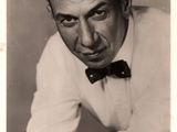 black and white photo of a man in a bow tie posing for a picture