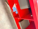a red cabinet with a tv on top of it