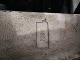 a close up of a piece of metal with a tag on it