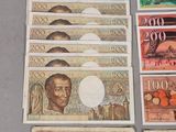 several different bank notes with a picture of a man on one of them