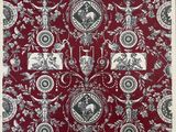 a close up of a red and white table cloth with black and white images