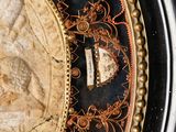 a close up of a clock with a roman numeral on it