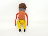 a small doll that is sitting on a white surface